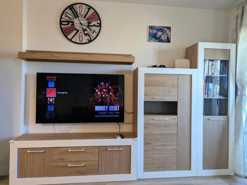 Smart TV and wooden cabinets in the living room