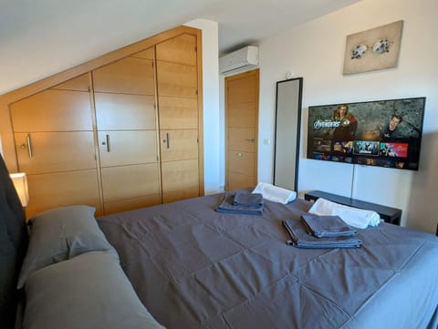 Bedroom with double bed, built-in wardrobes and smart TV