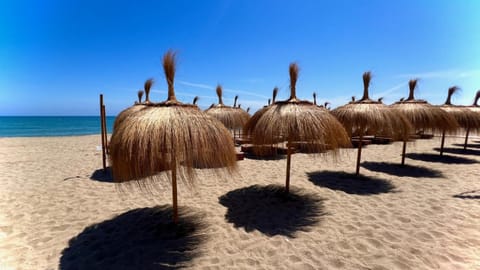 Straw parasols on Carvajal beach