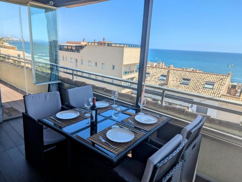 Table on the glazed terrace with a panoramic view of the coast