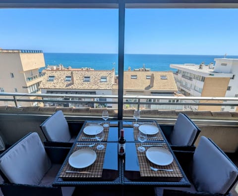 Dining table on the glazed terrace looking straight out to the sea